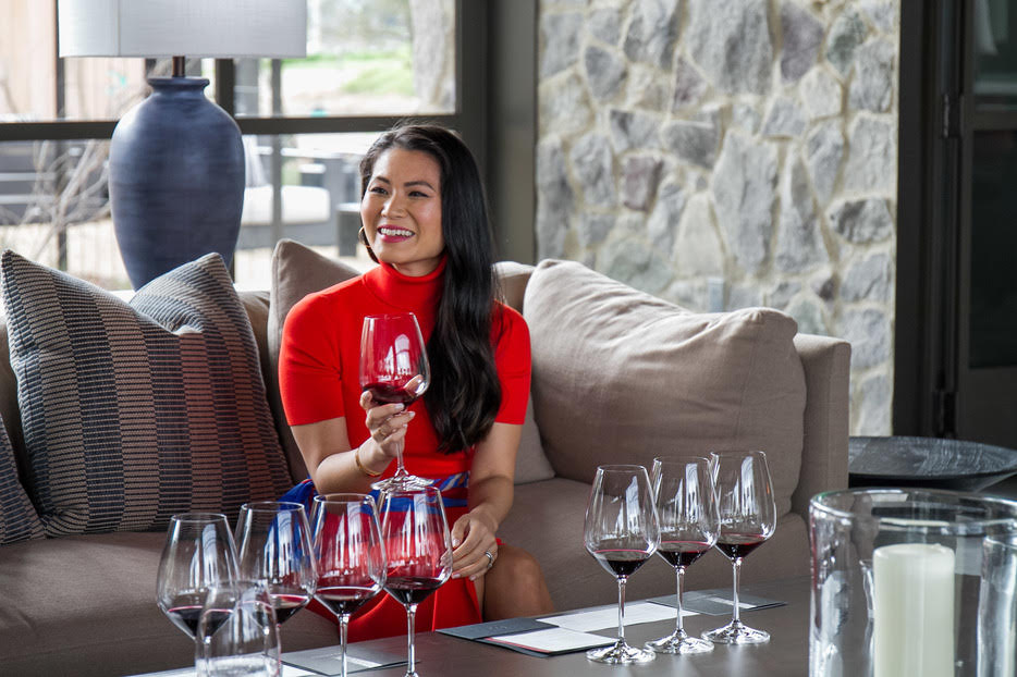 Susan Li sitting at a table with wine glasses
