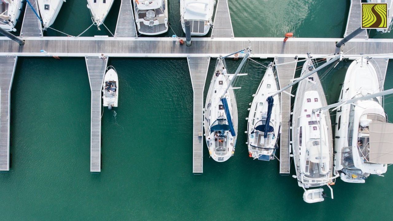 Aerial view of boats docked at a marina with green water.