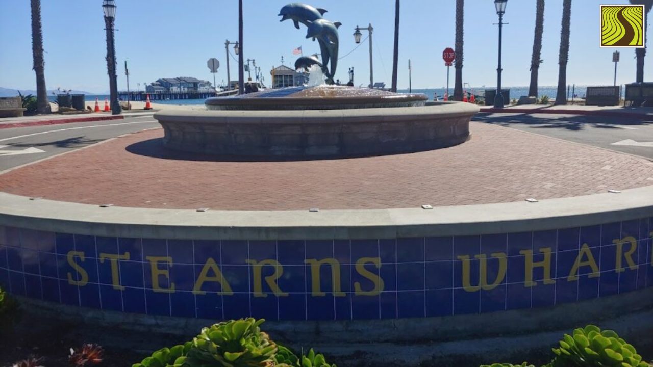 Stearns Wharf entrance with dolphin sculpture and ocean view.