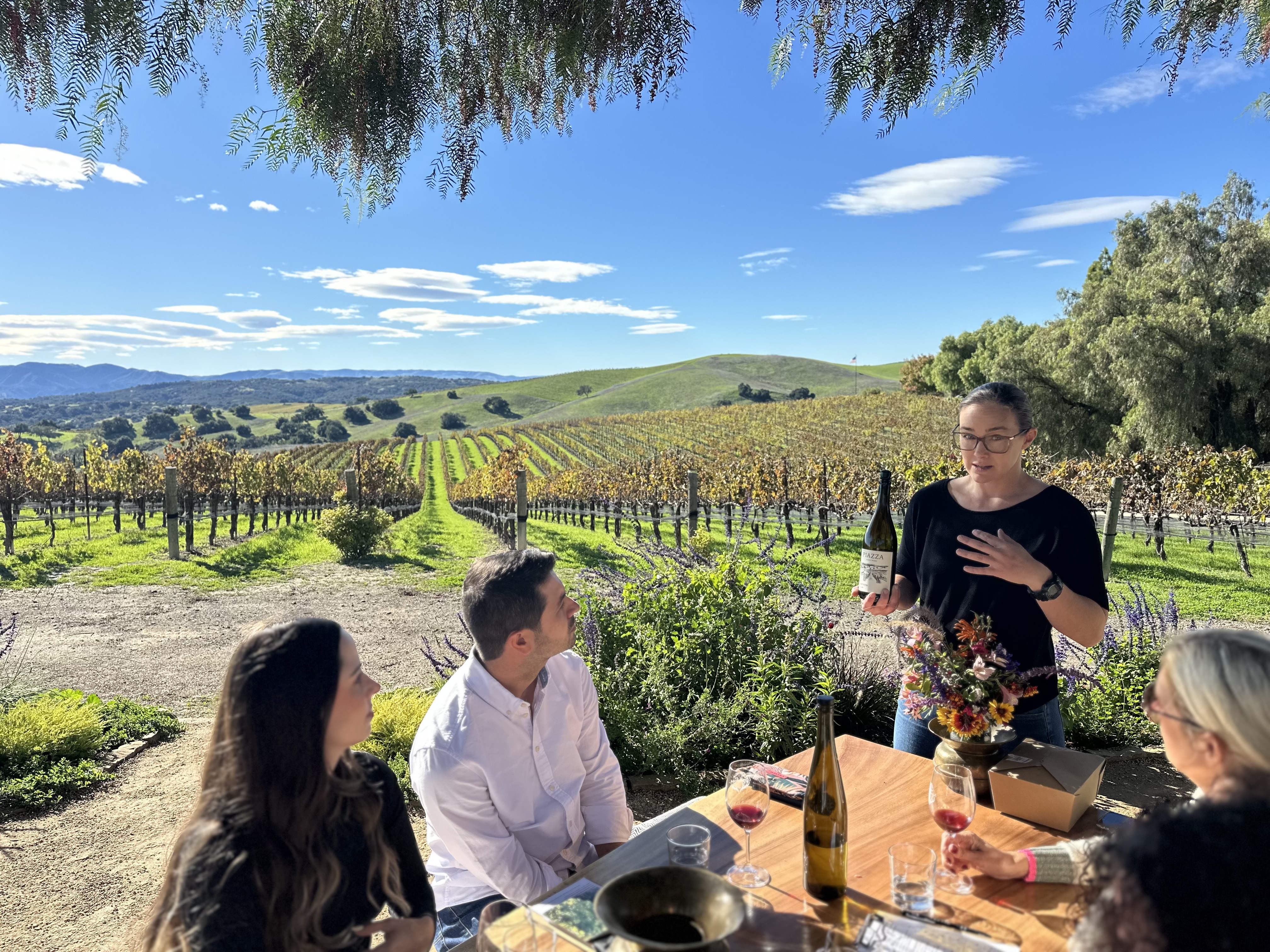 Guests enjoying private vineyard wine tour with guided tasting.