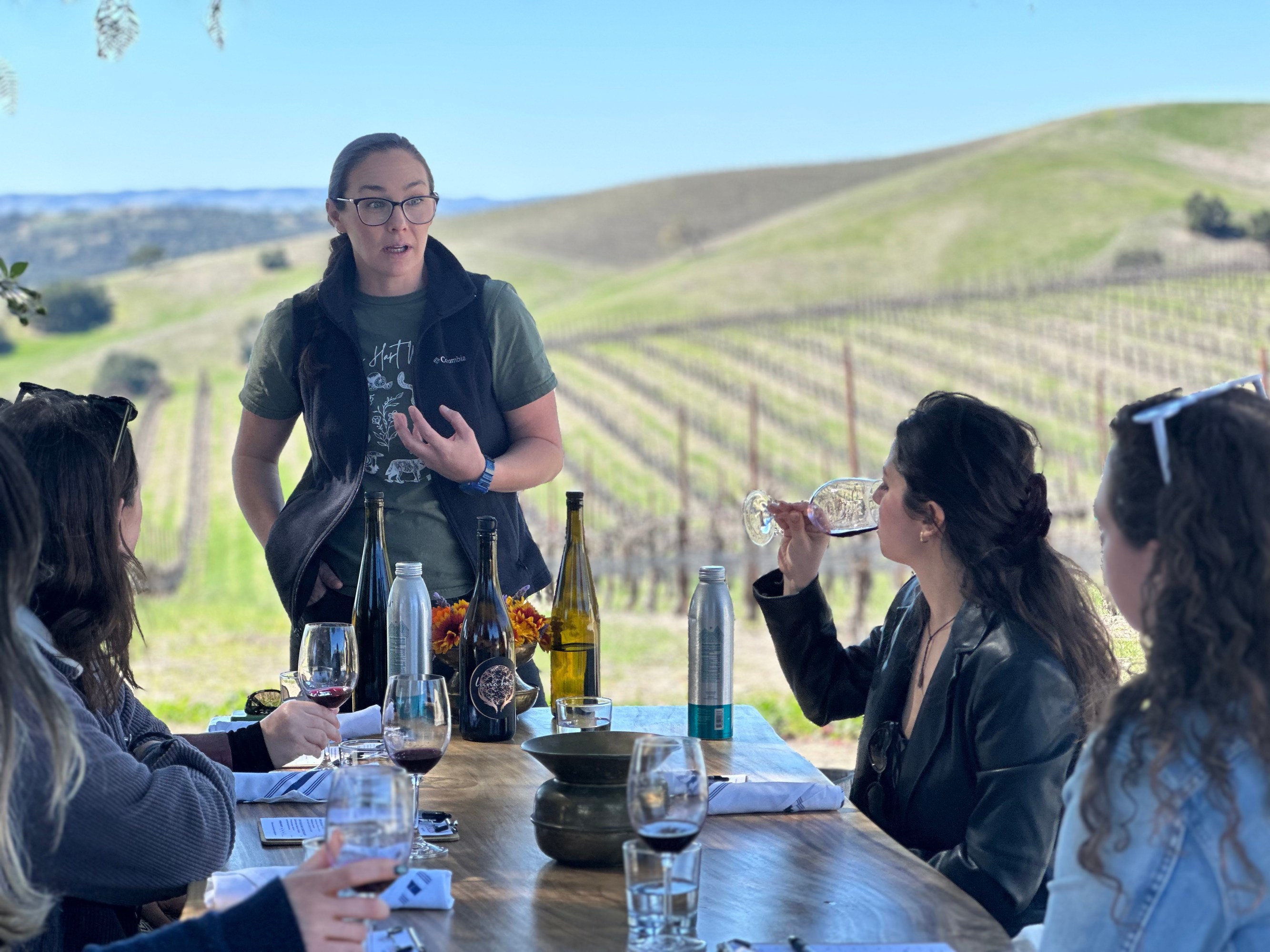 Guests enjoying private vineyard wine tour with guided tasting.